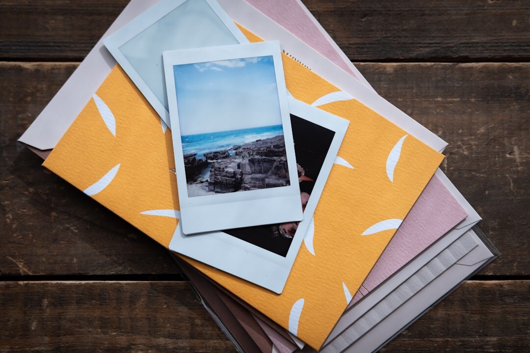 Photo prints and packaging materials arranged on a wooden table
