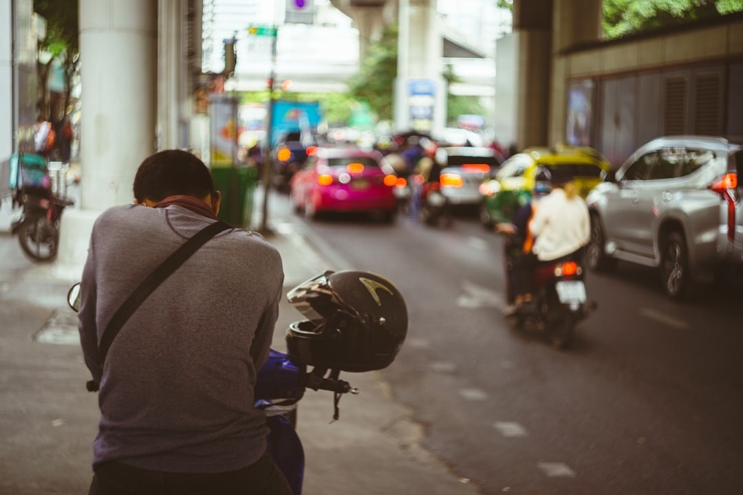 Professional photographer holding a camera while documenting a street scene