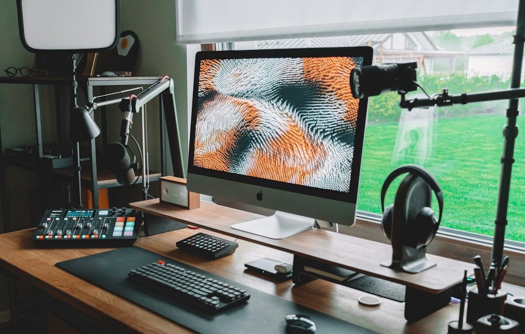 Small photography studio office with desk and camera equipment near a window