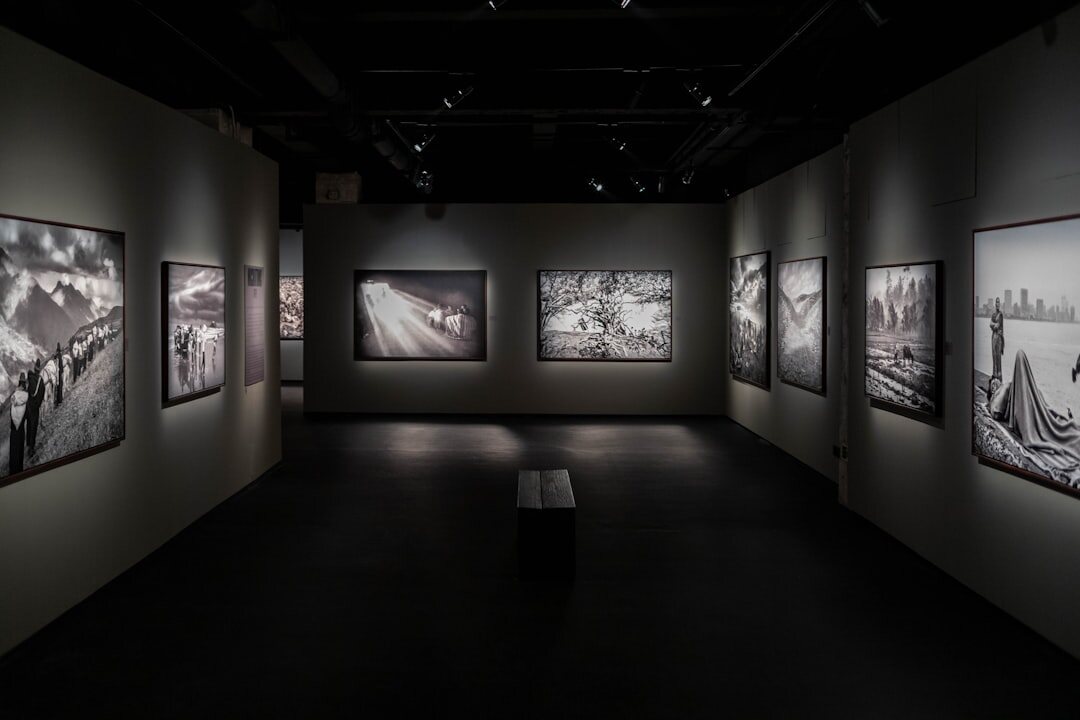 Black and white documentary photographs displayed in a gallery exhibition